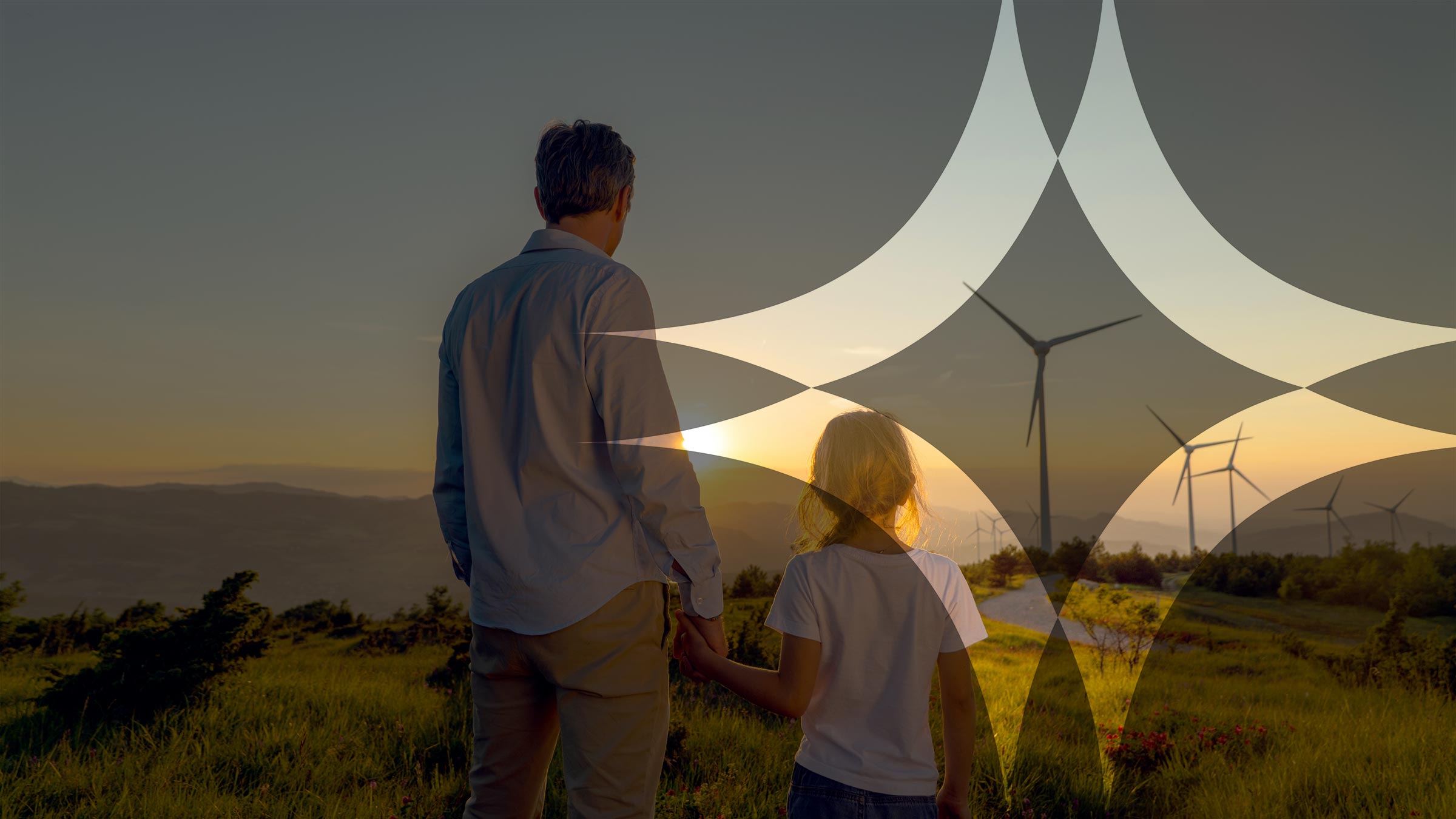 Man and child looking at wind turbines